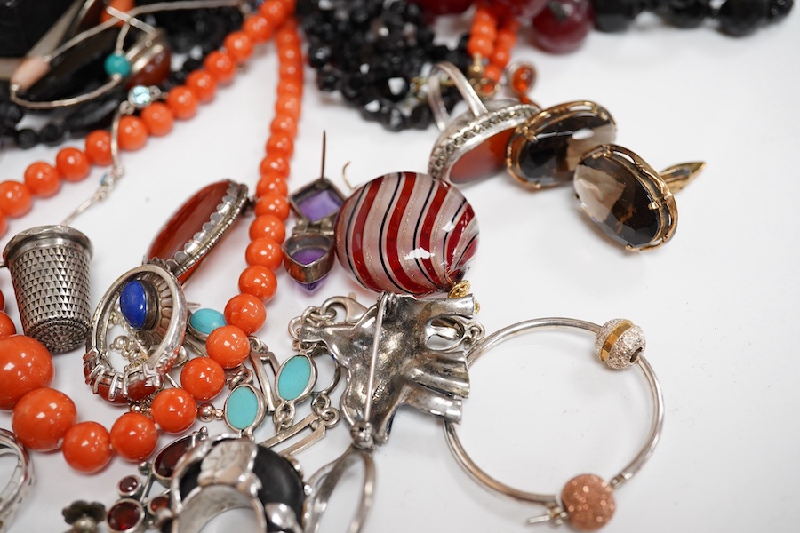 A quantity of assorted silver and costume jewellery including a Georg Jensen style brooch, a graduated coral bead necklace, 56cm, gross weight 35 grams, pair of coral drop earrings, a George V silver combination latter o